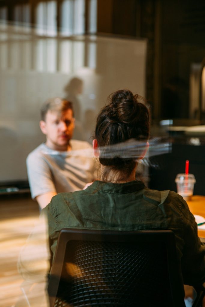 A man and a woman are sitting and talking