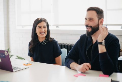 A woman and a man are sitting at a table talking