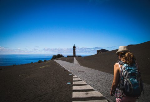 A woman is walking down a path toward a goal