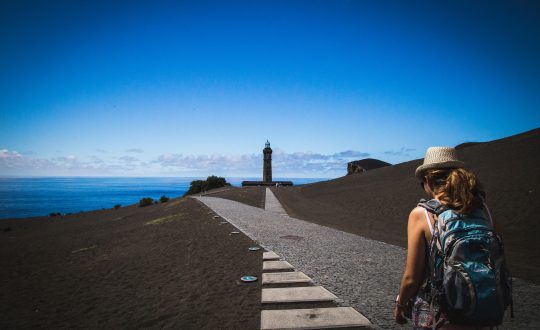 A woman is walking down a path toward a goal