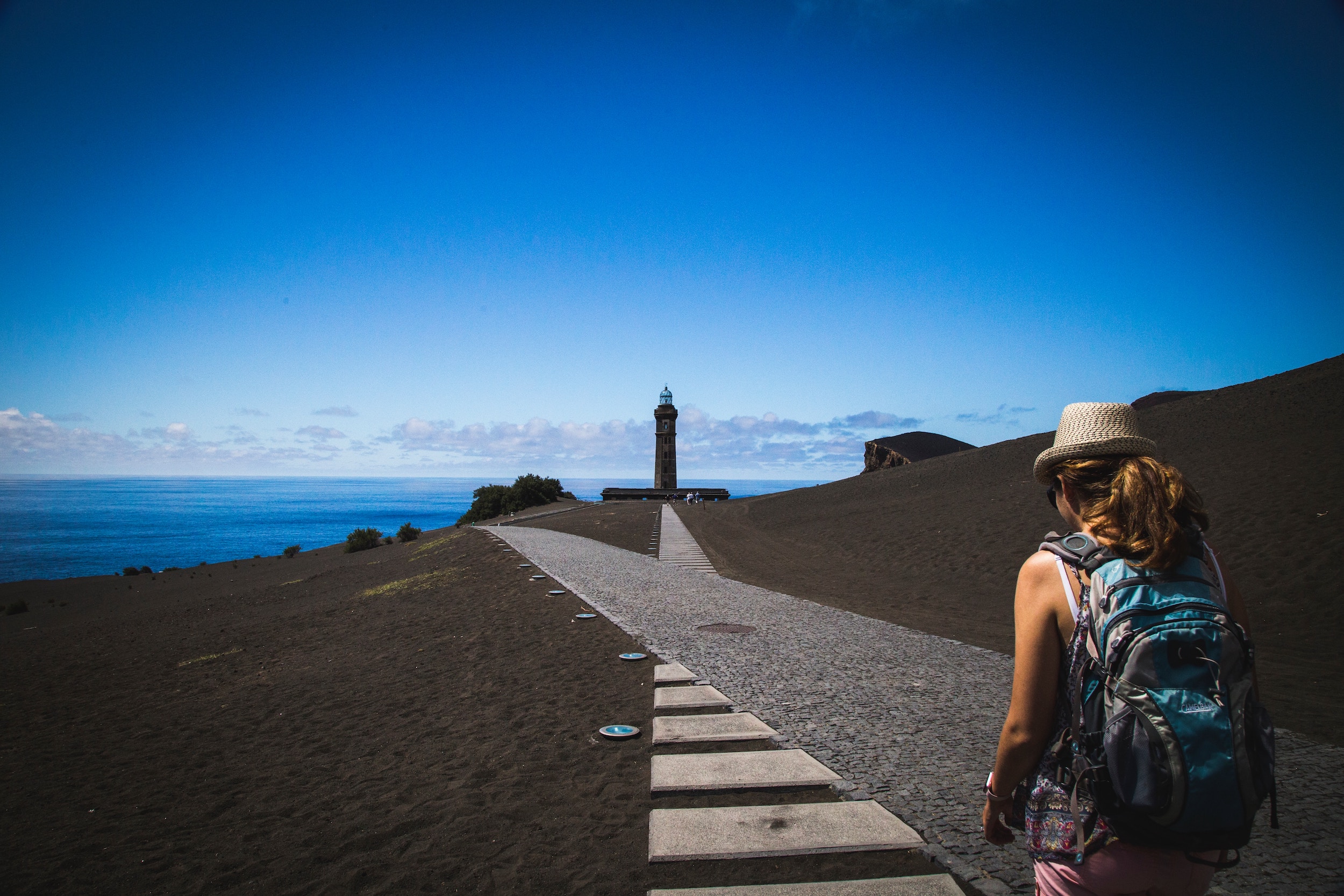 A woman is walking down a path toward a goal