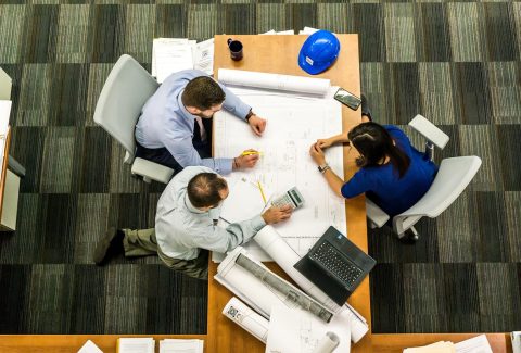 A group of people are sitting at a a table and talking
