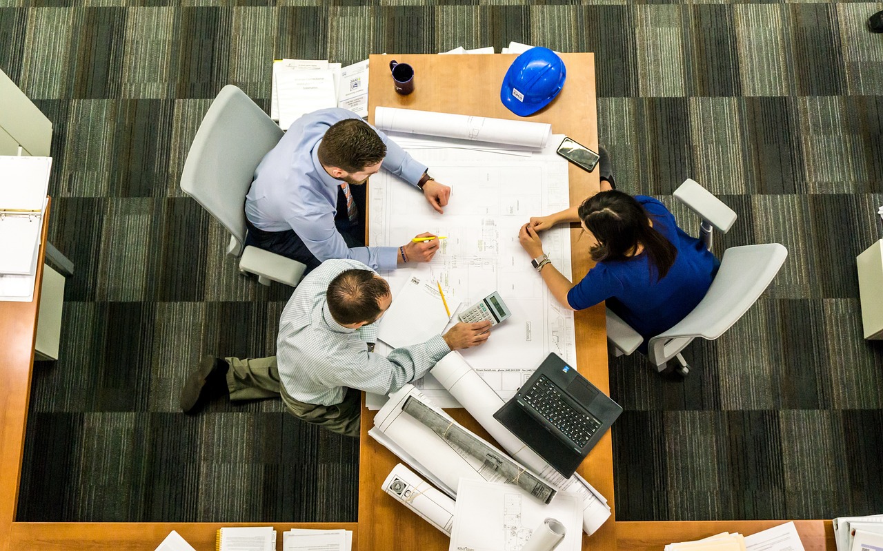 A group of people are sitting at a a table and talking
