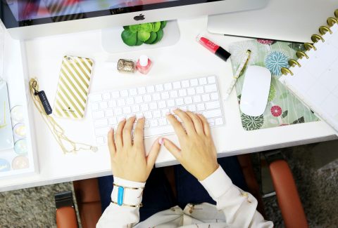 Someone is sitting at a computer working