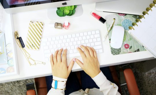 Someone is sitting at a computer working