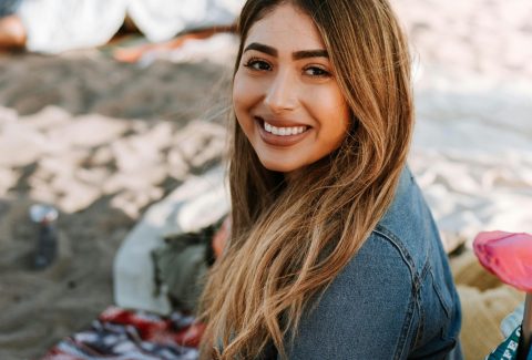 A business woman is standing and smiling