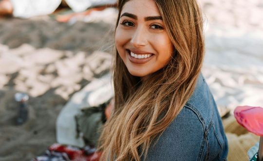A business woman is standing and smiling