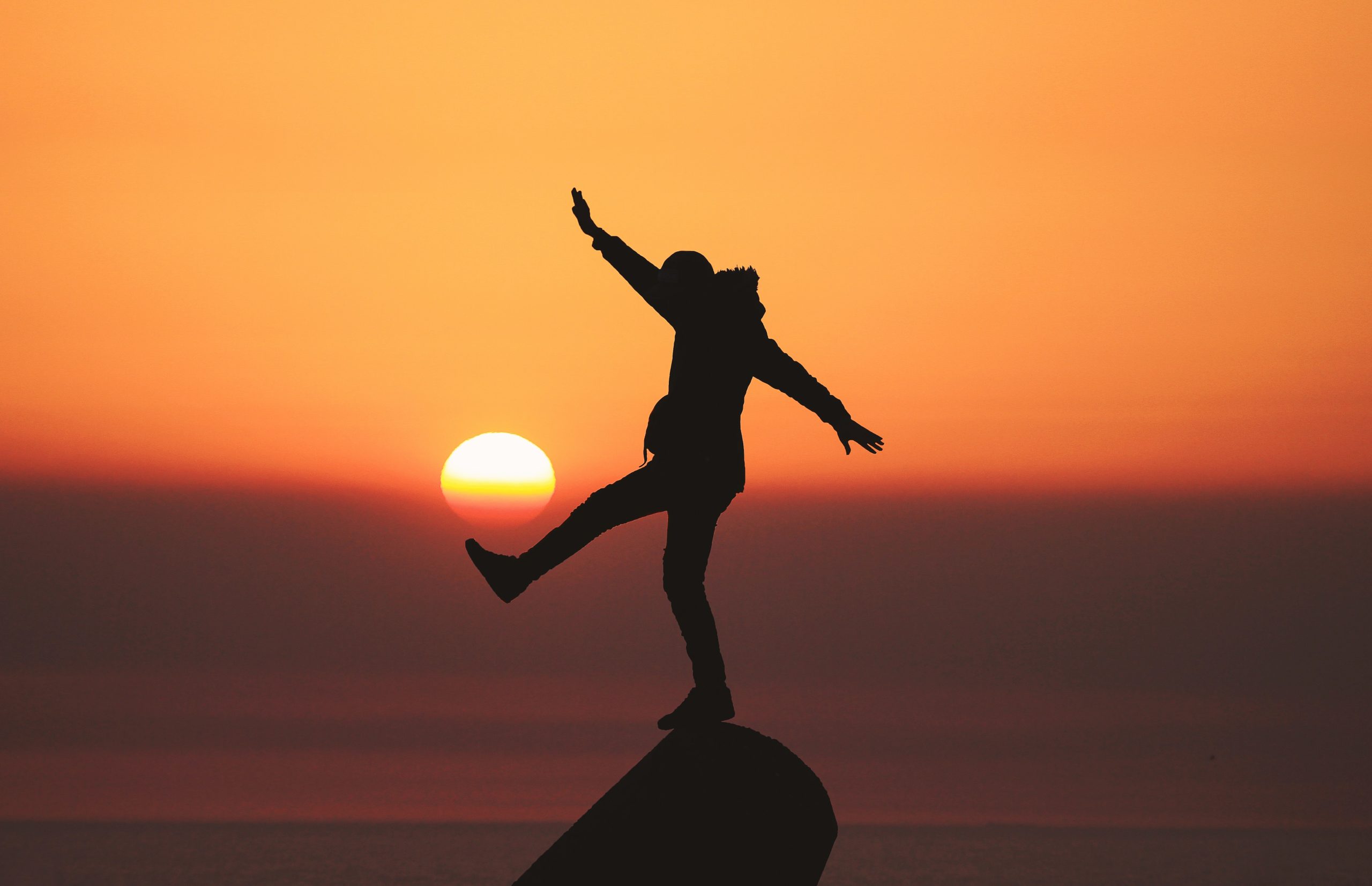 A person is standing on top of a rock outcrop