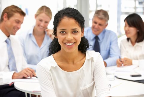 A woman is standing in front of a work table