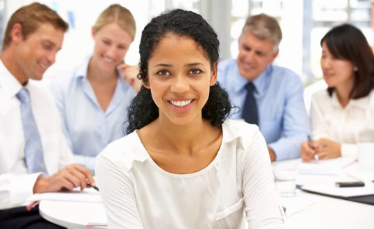 A woman is standing in front of a work table