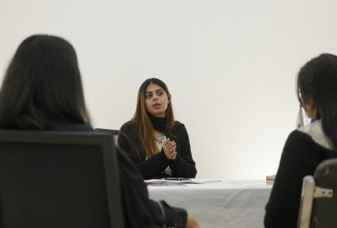 A group of woman are sitting and talking