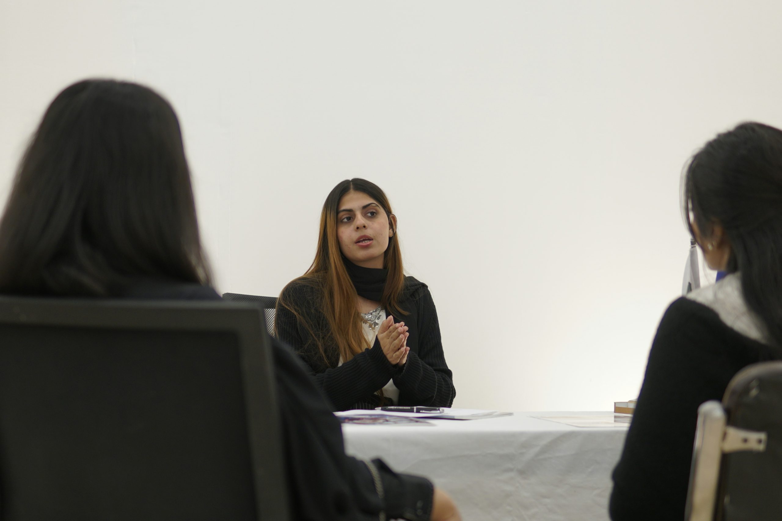 A group of woman are sitting and talking