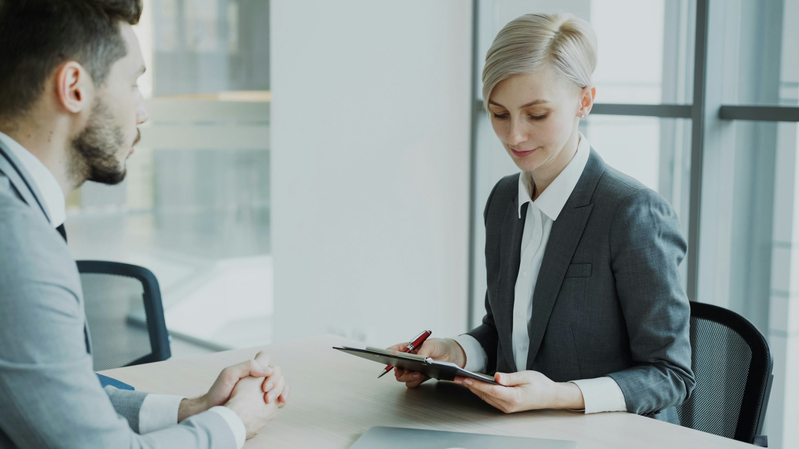 A business woman is standing and reading