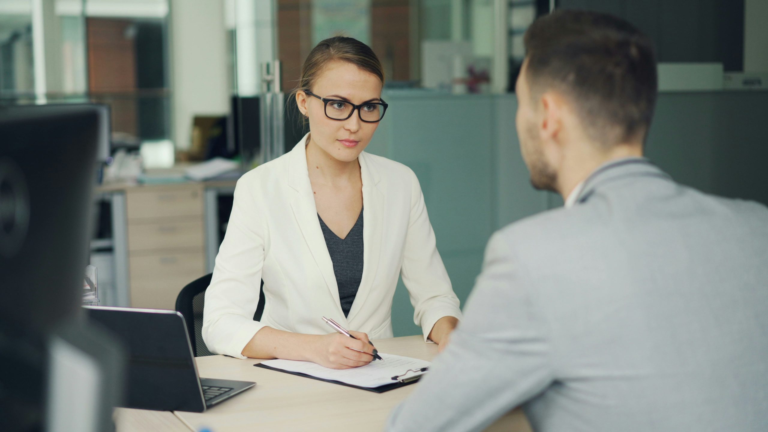 A business man and woman are sitting and talking