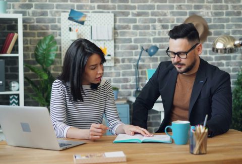 A man and a woman are sitting and talking