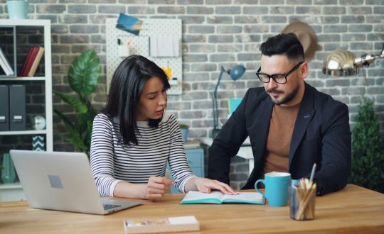 A man and a woman are sitting and talking