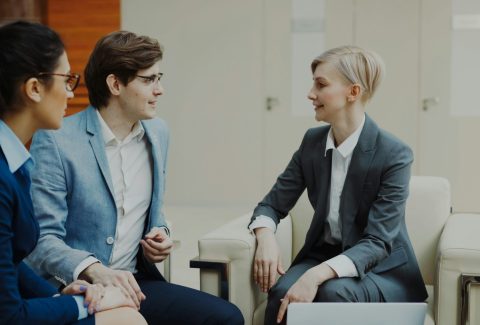 Business men and woman are sitting and talking