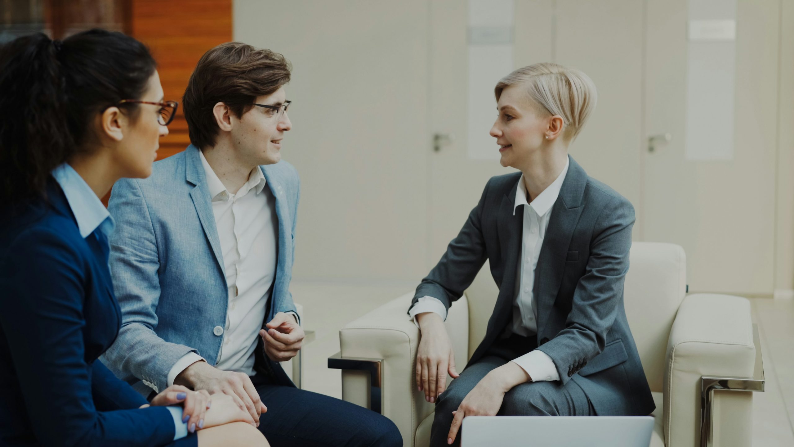 Business men and woman are sitting and talking